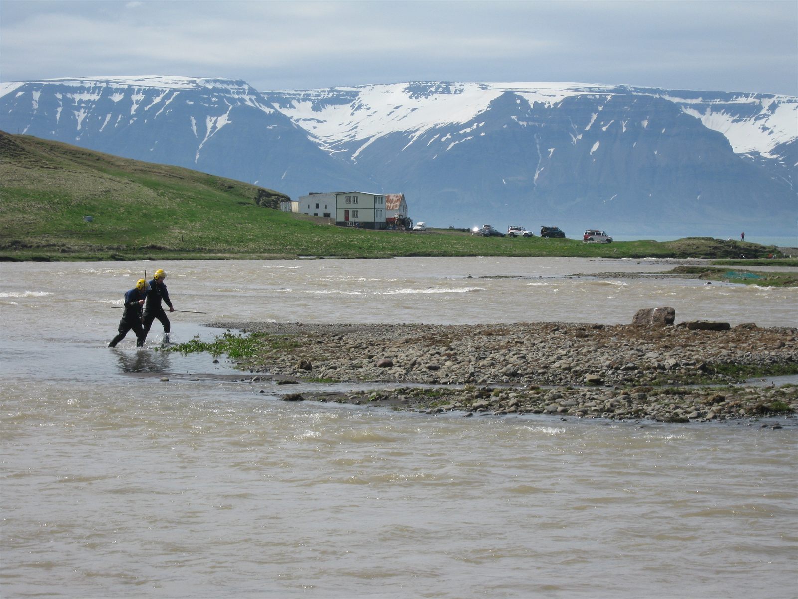 Searchers working along the flooded Hjaltadalsá river in Skagafjörður